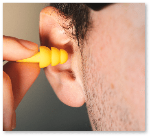 Man using hearing protection to prevent hearing loss