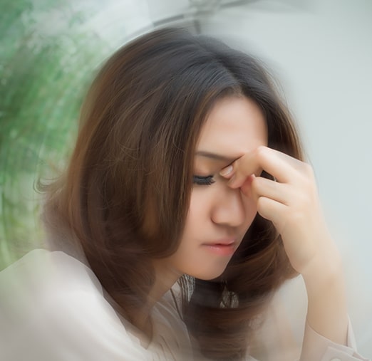 Woman experiencing dizziness and lightheadedness